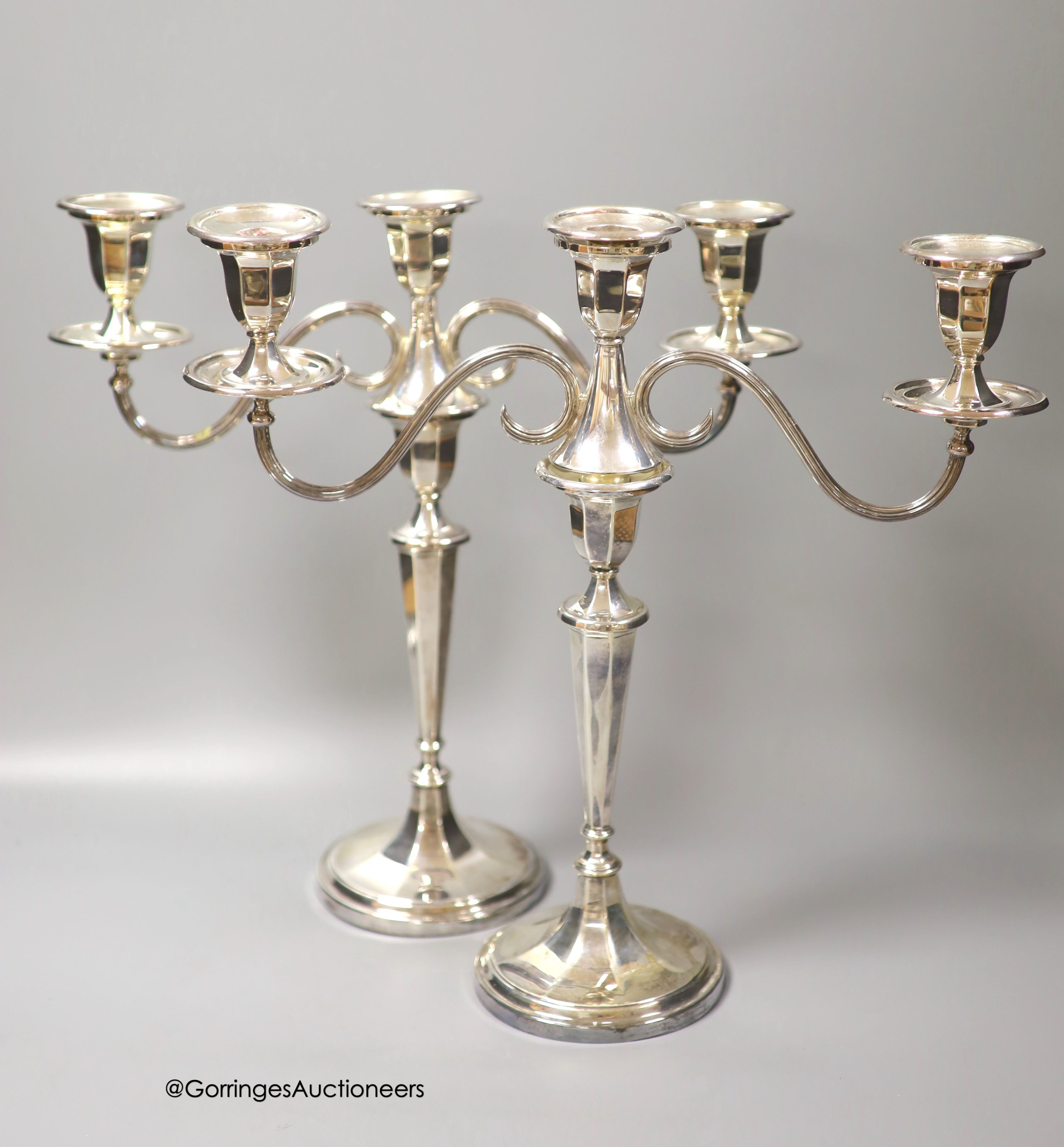 A modern pair of silver two branch, three light candelabra by C.J. Vander Ltd, Sheffield, 1962 & 1964, height 37cm, weighted (a.f.)